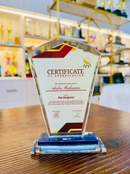 Custom crystal appreciation plaque with faceted pentagon shape, burgundy red and gold printed details, and blue crystal base