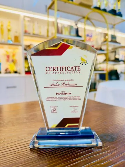 Custom crystal appreciation plaque with faceted pentagon shape, burgundy red and gold printed details, and blue crystal base